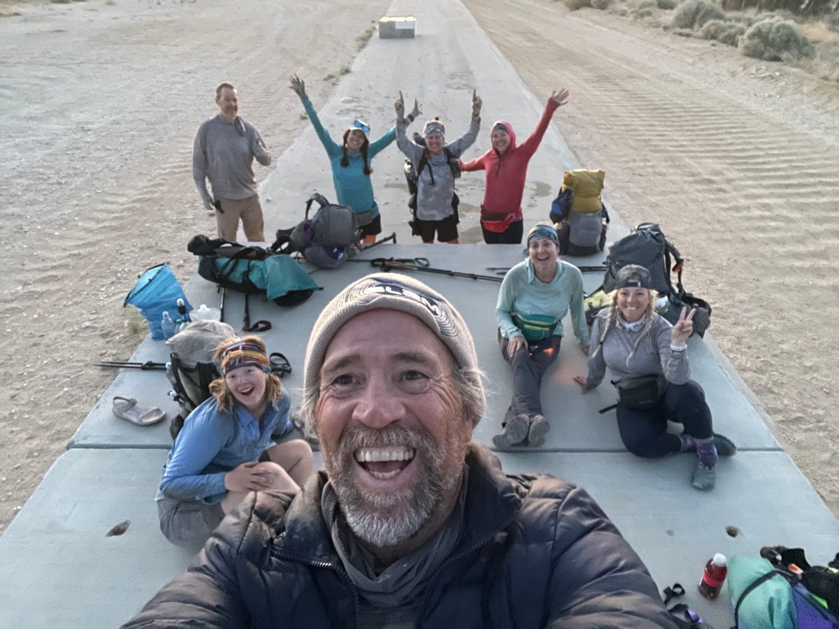 Trail angel Scott Maloy greets his daughter Audrey (bottom left) and her thru-hiking “family” along the PCT.
