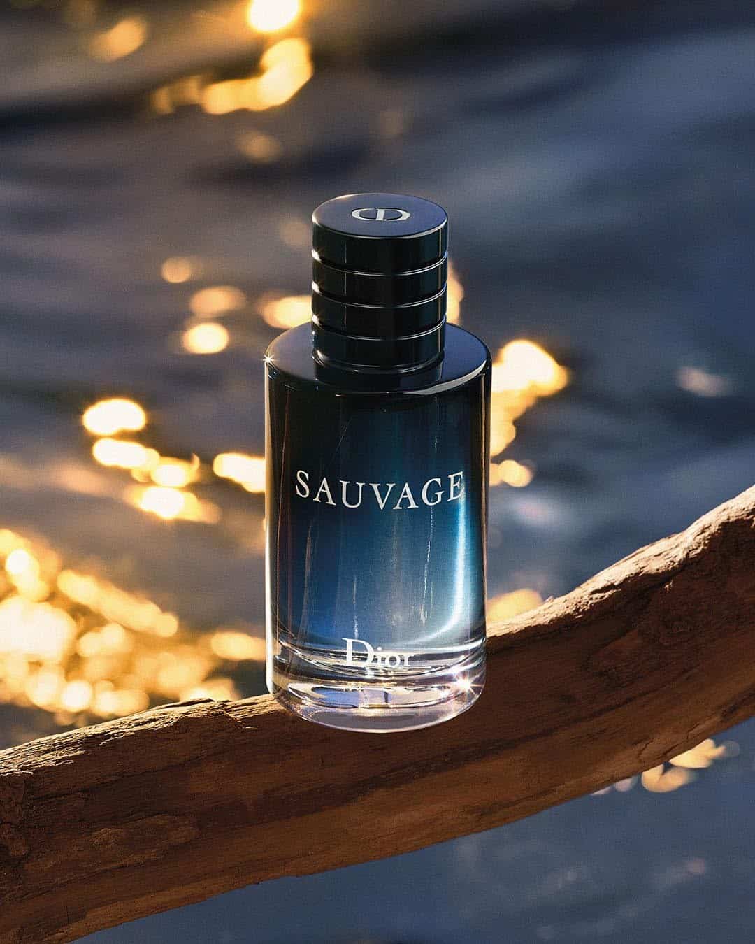 a bottle of Dior Sauvage on top of a branch