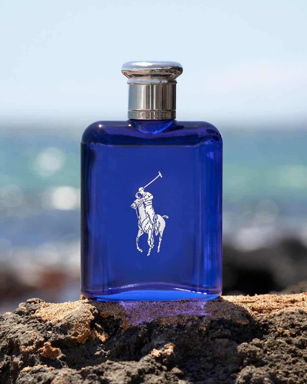 a bottle of ralph lauren polo blue on top of a rock