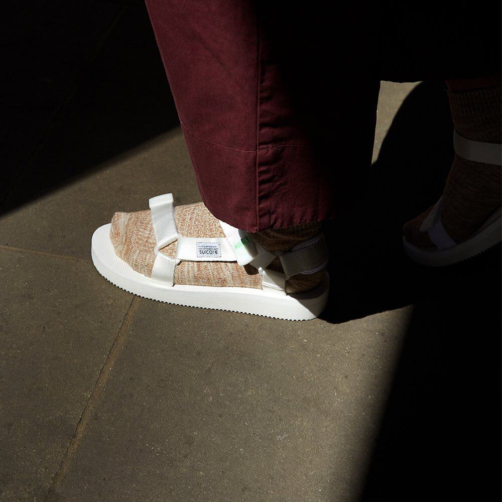wearing a pair of white Suicoke Depa-Cab