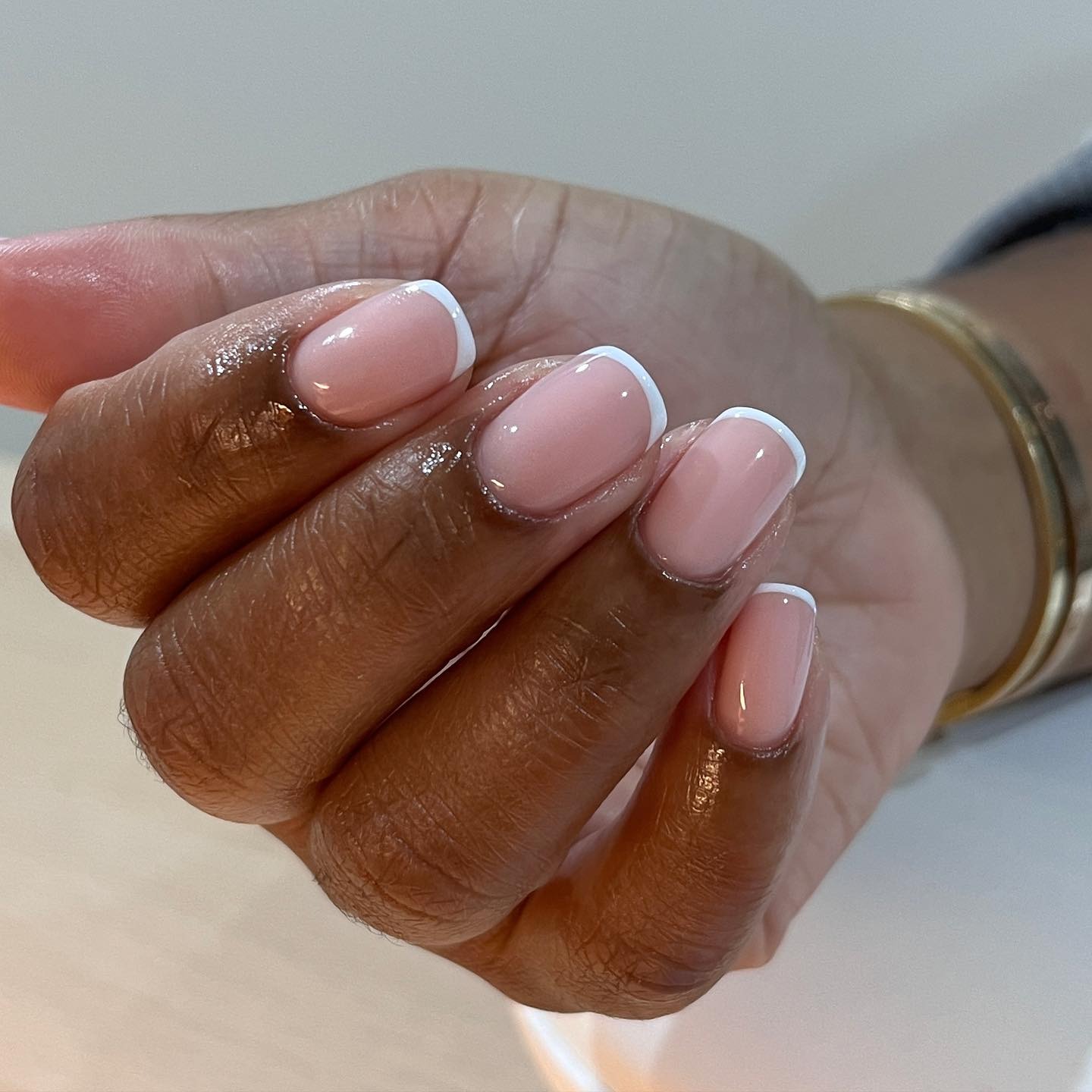 A slightly rounded glass French manicure