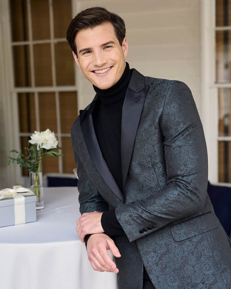 man wearing a tuxedo suit with flower patterns